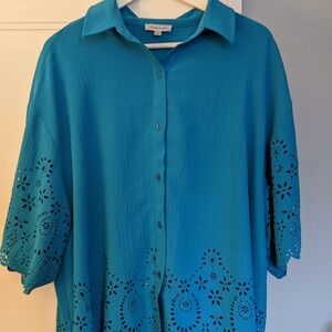 Button down blue blouse with cut outs at sleeves and bottom of blouse